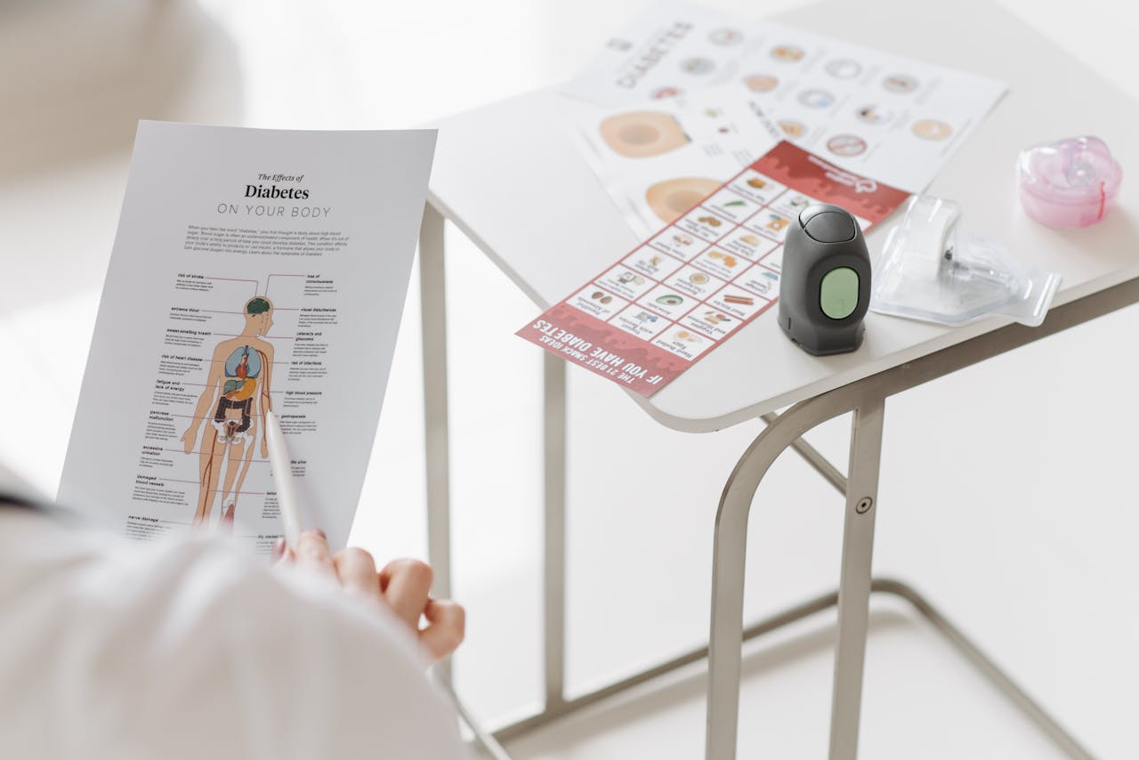 Close-up of diabetes management tools and educational materials on a table.